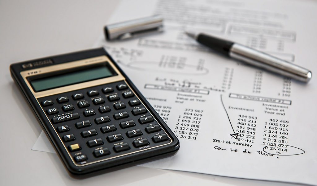 A paper and a calculator depicting the cost of insurance when furniture dismantling, reassembling and assembly in Warrington.